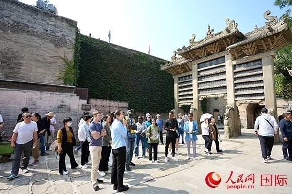 選手們認真聆聽導游講解。人民網(wǎng) 盧鵬宇攝