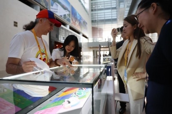 10月16日，參會(huì)記者在“一帶一路”國際合作高峰論壇新聞中心參觀展示的中國非物質(zhì)文化遺產(chǎn)展品。新華社記者 陳斌 攝