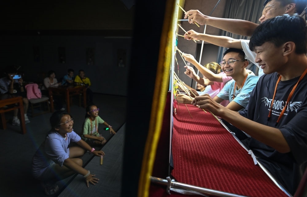 2023年8月8日，進(jìn)行暑期研學(xué)的學(xué)生在位于陜西省西安市的中國(guó)秦腔藝術(shù)博物館體驗(yàn)皮影戲演出。新華社記者 鄒競(jìng)一 攝