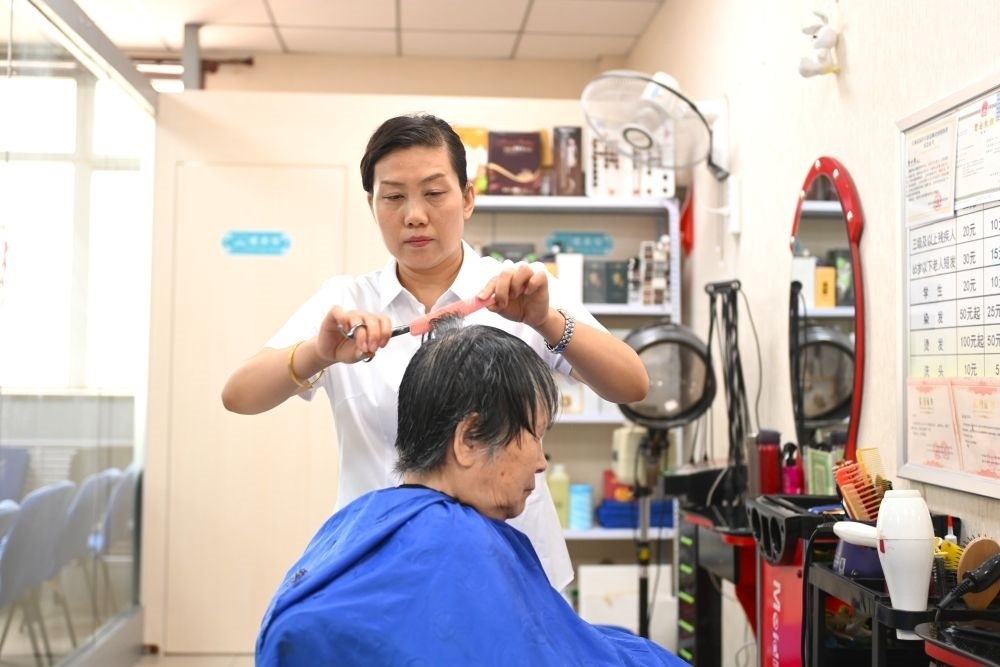 6月20日，長城花園社區(qū)的志愿者為居民理發(fā)。