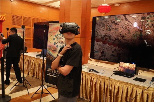 1、在本次活動的展覽現(xiàn)場，敦煌研究院與騰訊展示了“數(shù)字藏經(jīng)洞”和“尋境敦煌”等創(chuàng)新互動產(chǎn)品。圖為當?shù)孛癖娡ㄟ^VR虛擬游覽洞窟。 人民網(wǎng)記者 李志偉攝