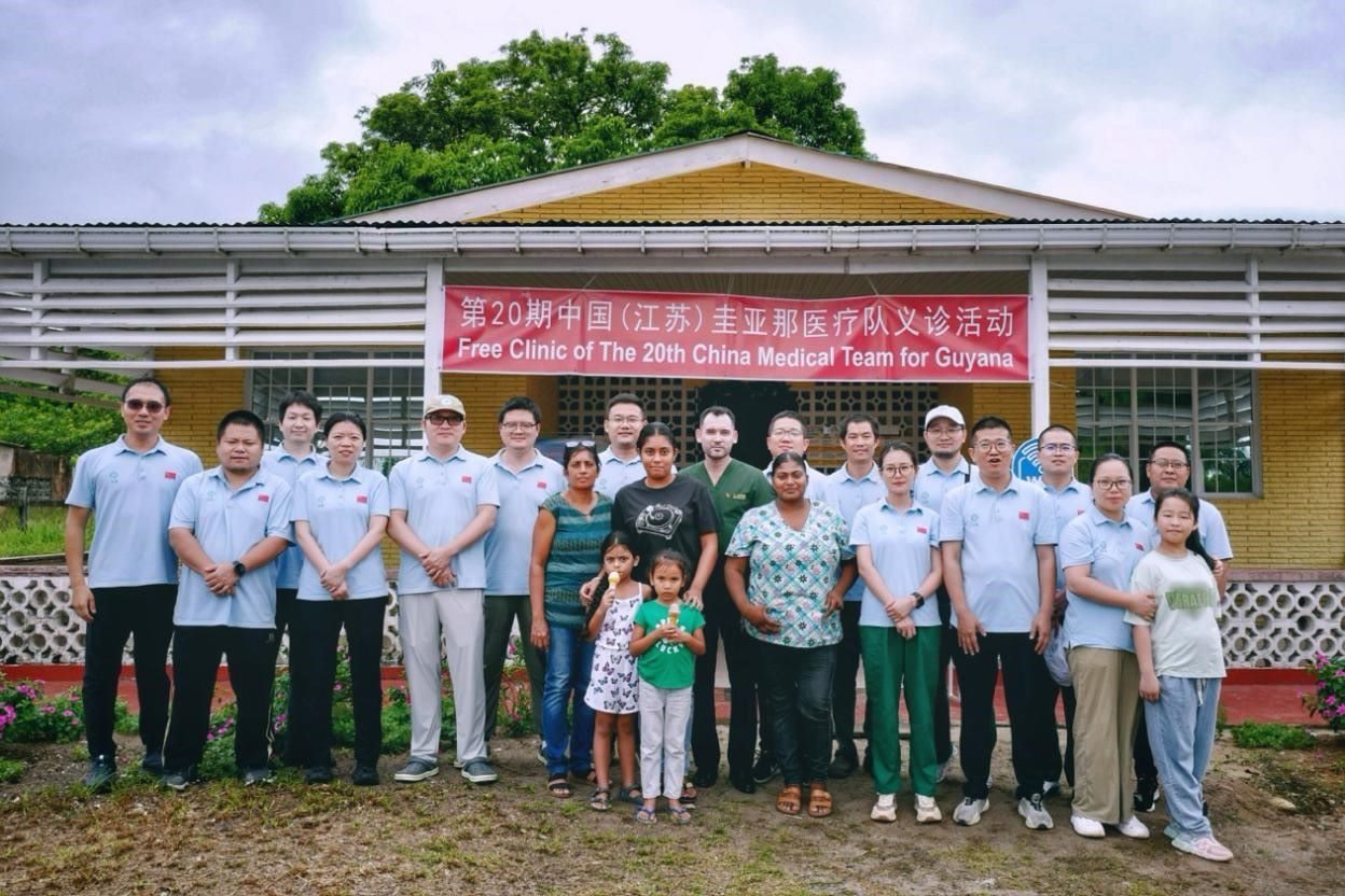 第20期中國（江蘇）援圭亞那醫(yī)療隊(duì)在圭偏遠(yuǎn)的林登高速社區(qū)開展義診后，與部分當(dāng)?shù)鼐用窈嫌啊?中國援圭醫(yī)療隊(duì)供圖